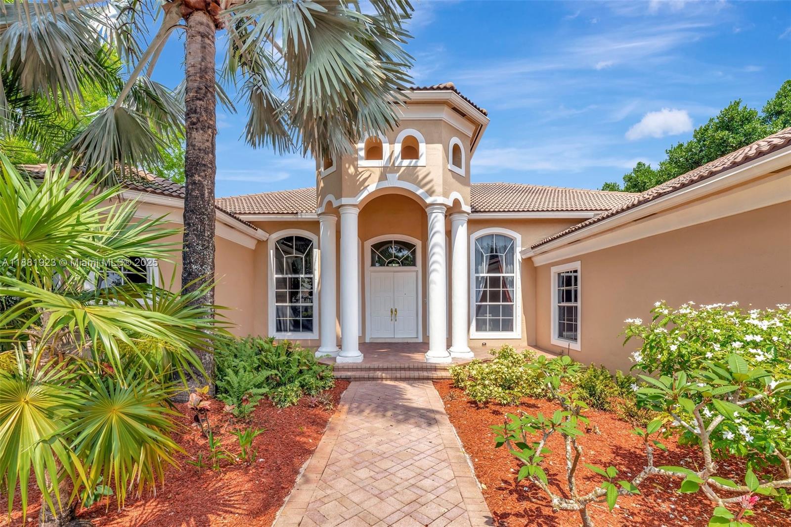 3203 West Stonebrook Circle Davie, FL 33330 - Photo 4 of 51 a front view of a house with a garden