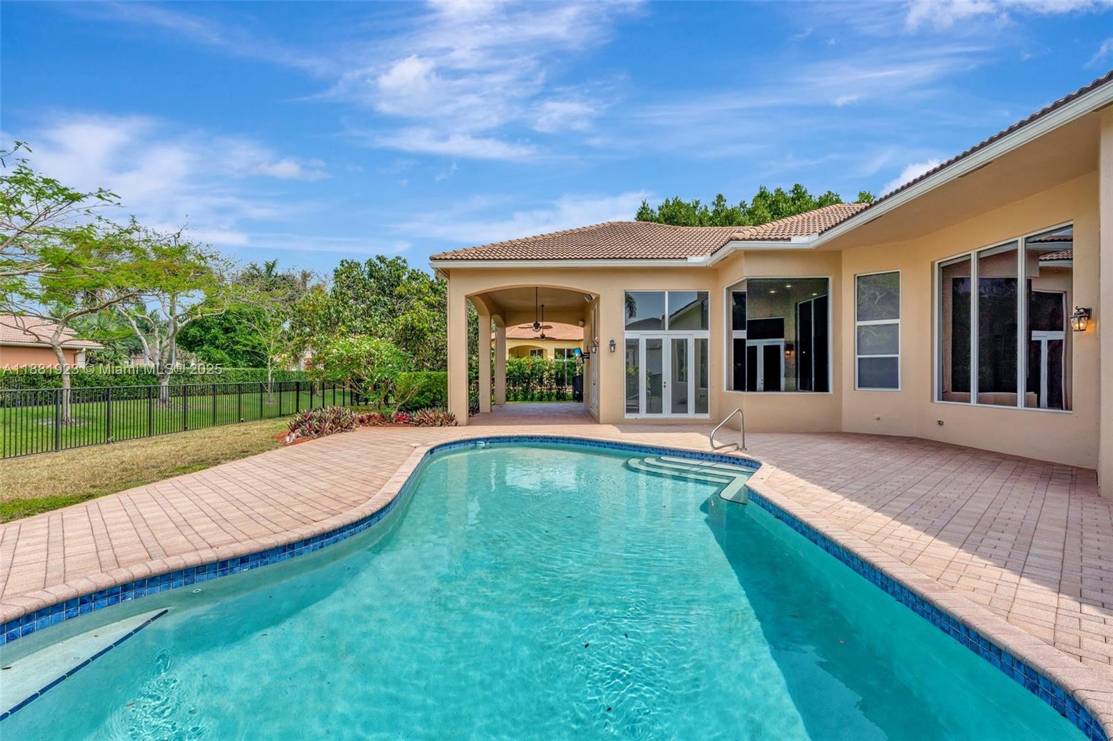 3203 West Stonebrook Circle Davie, FL 33330 - Photo 45 of 51 a view of swimming pool with lawn chairs and large trees