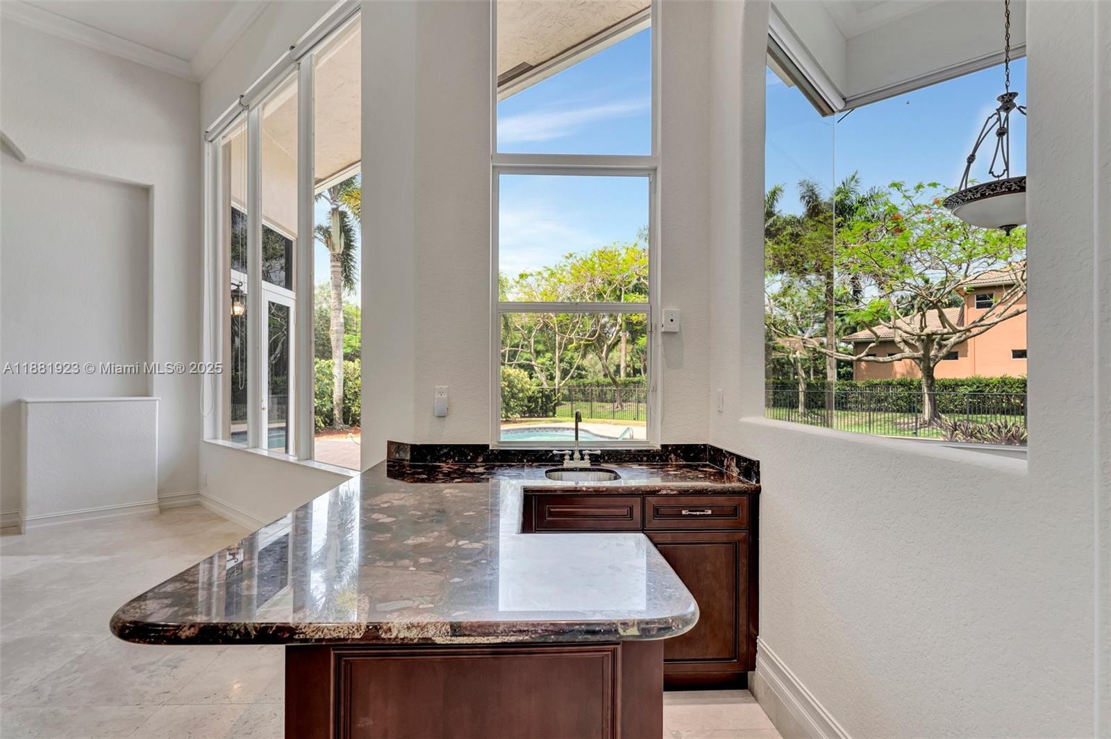 3203 West Stonebrook Circle Davie, FL 33330 - Photo 8 of 51 a kitchen with counter top space and windows