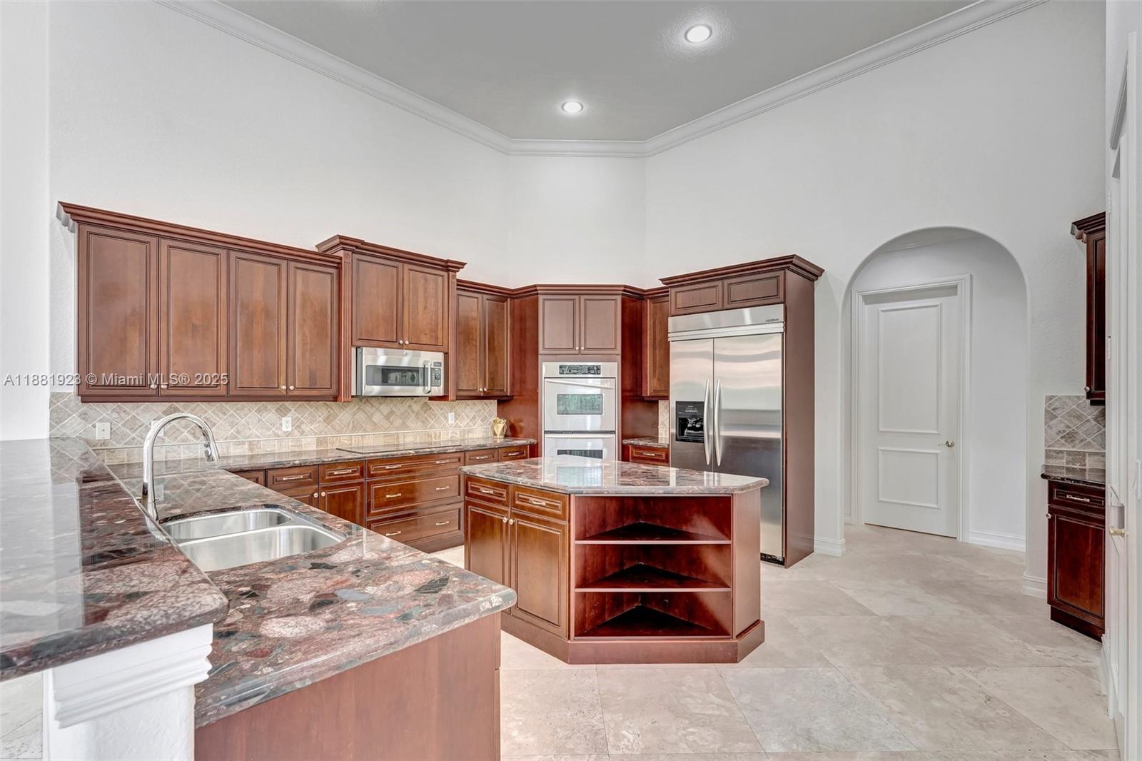 3203 West Stonebrook Circle Davie, FL 33330 - Photo 10 of 51 a kitchen with stainless steel appliances granite countertop a stove sink and cabinets