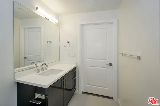 a bathroom with a sink a mirror and a shower