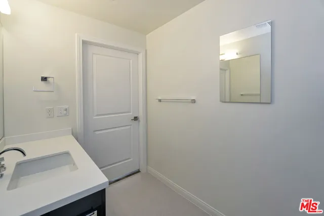 a bathroom with a sink and mirror