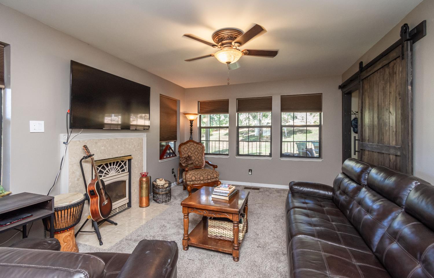 10151 Trauner Road Rough and Ready, CA 95975 - Photo 21 of 45 a living room with furniture a fireplace and a flat screen tv