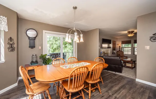 a dining room with furniture a chandelier and wooden floor