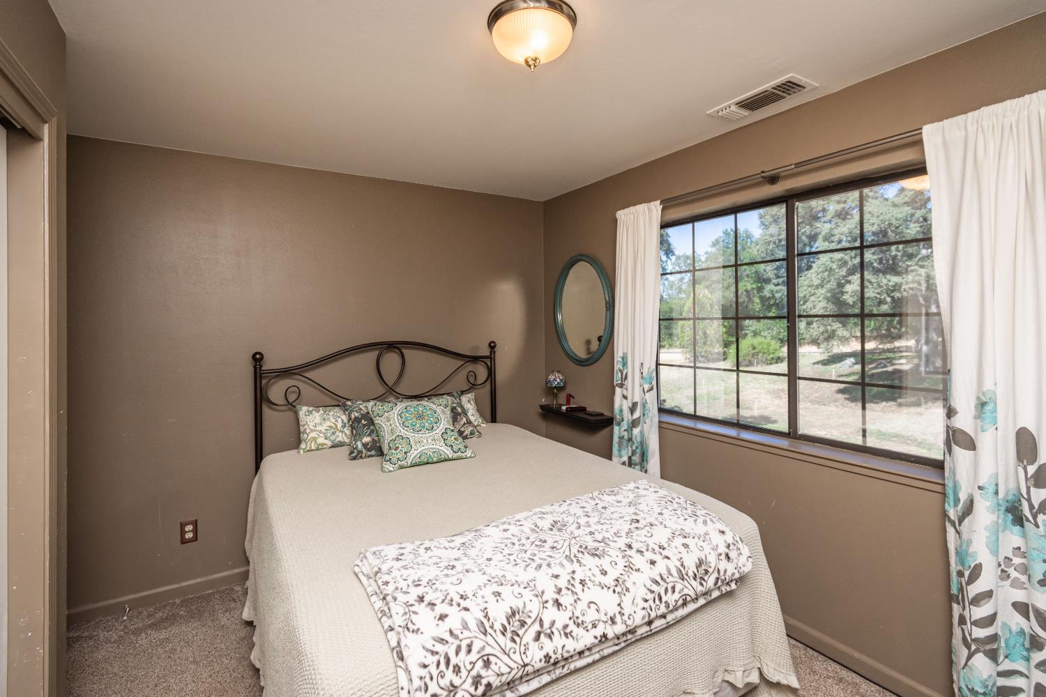 10151 Trauner Road Rough and Ready, CA 95975 - Photo 26 of 45 a bedroom with a bed and window