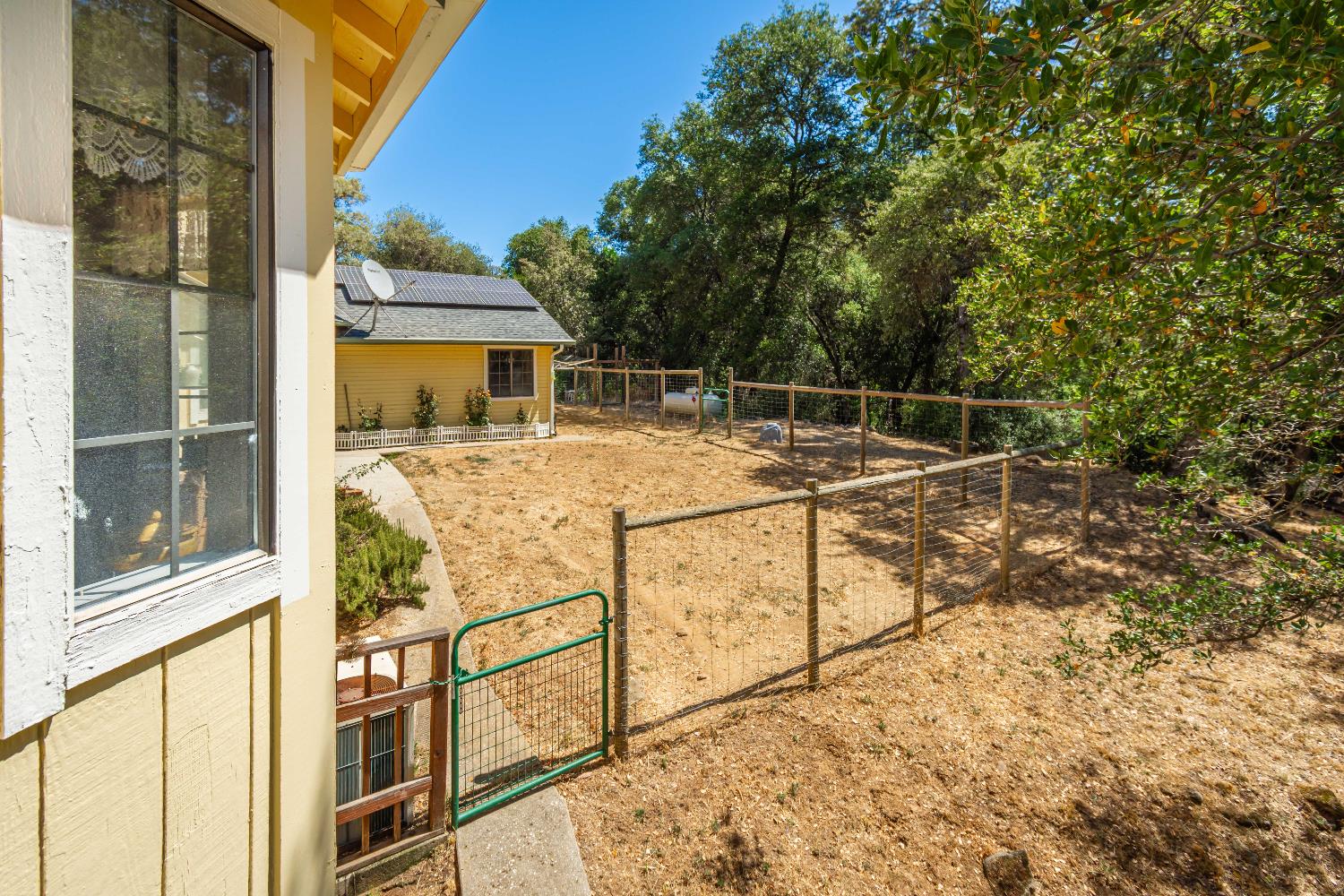 10151 Trauner Road Rough and Ready, CA 95975 - Photo 32 of 45 a view of a balcony with wooden floor and iron fence