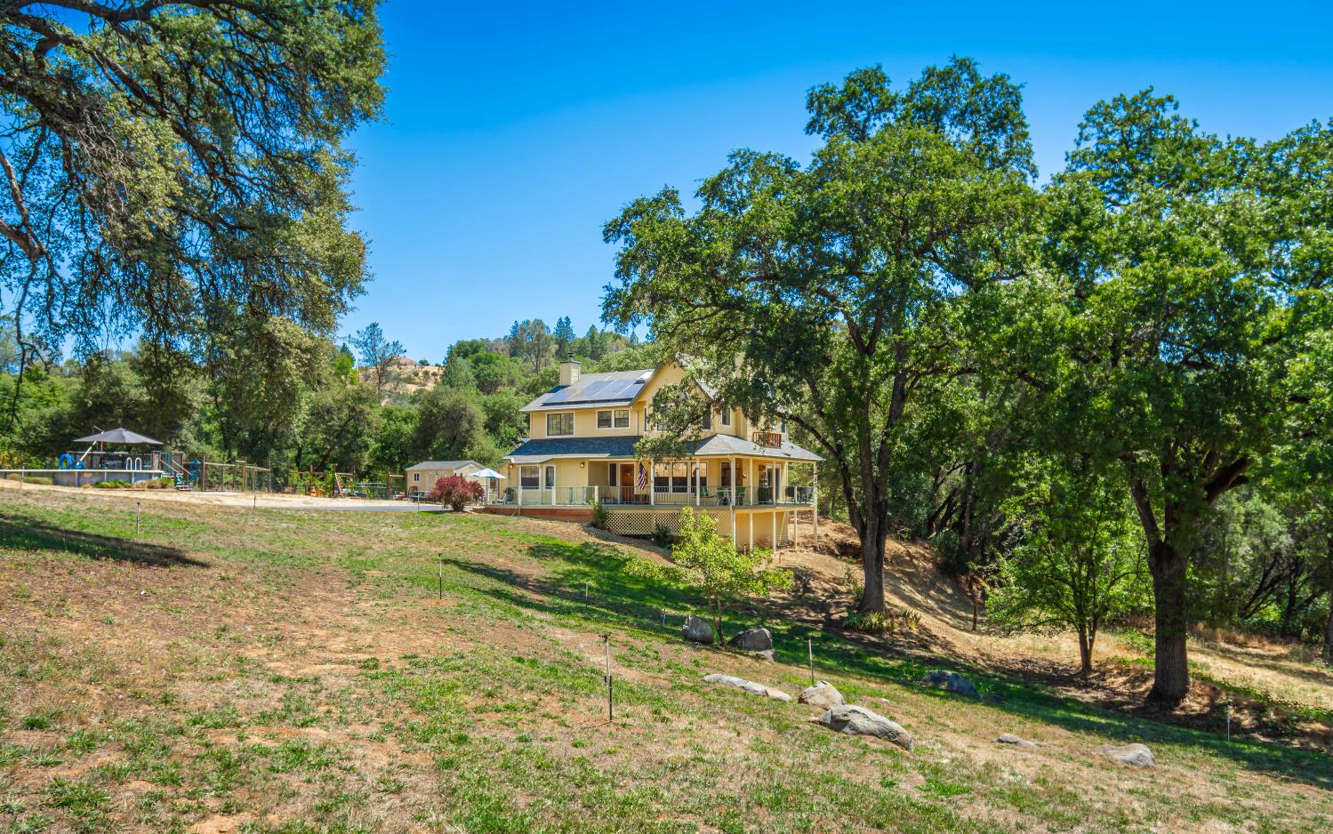 10151 Trauner Road Rough and Ready, CA 95975 - Photo 41 of 45 a house with trees in front of it