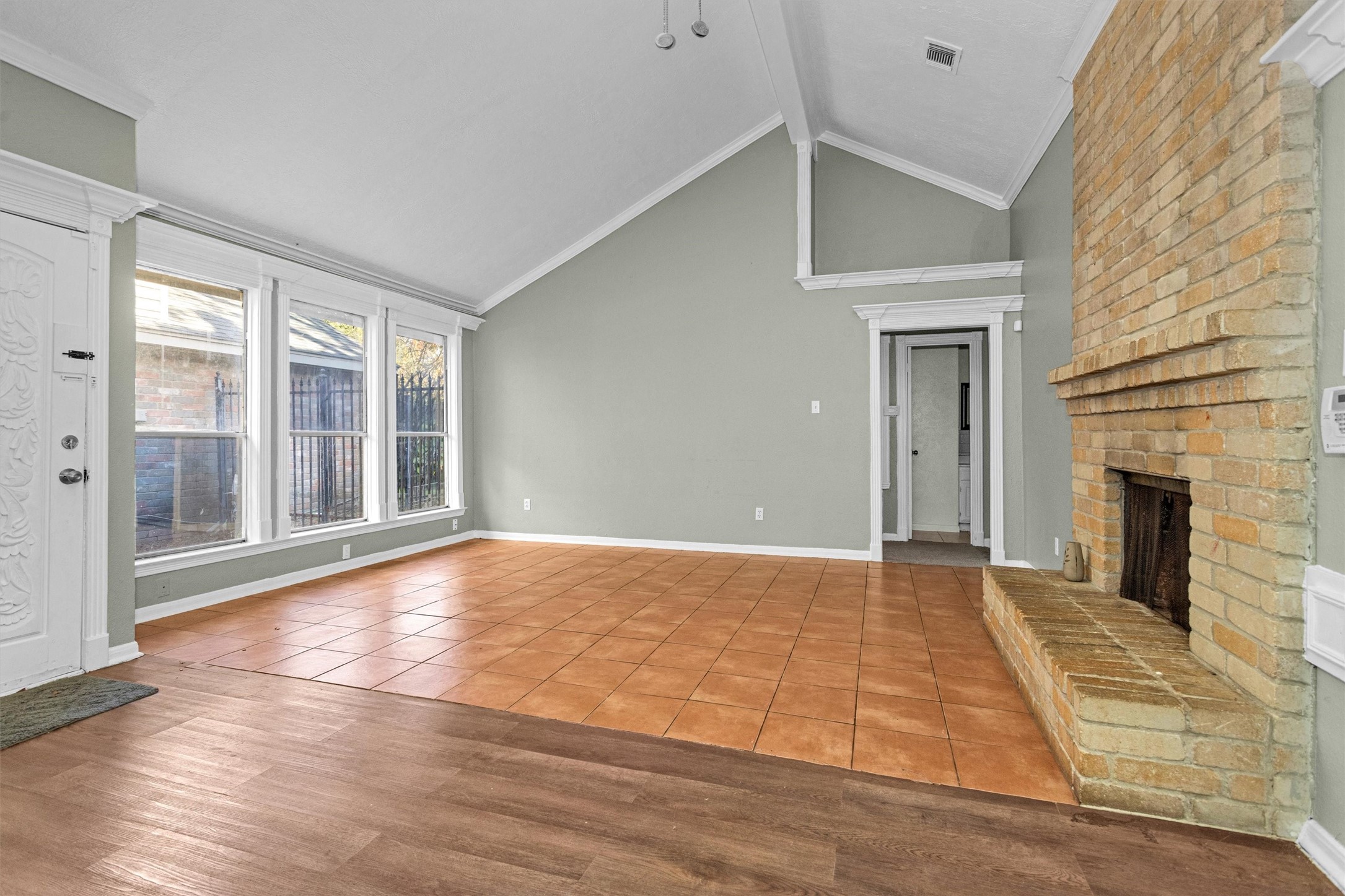12443 South Rachlin Circle Houston, TX 77071 - Photo 9 of 29 a view of an empty room with wooden floor fireplace and a window