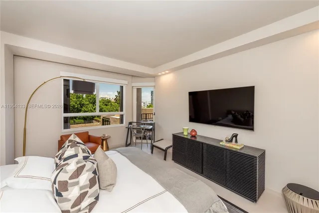 a view of a livingroom with workspace and a large window