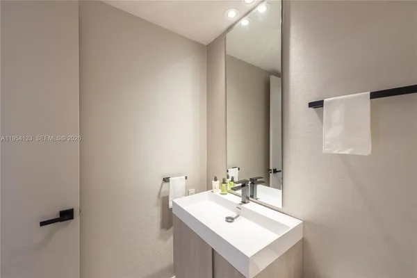 a bathroom with a sink mirror and vanity