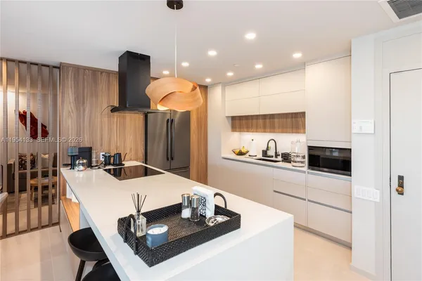 a kitchen with a dining table and chairs