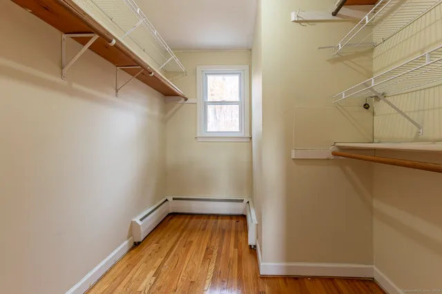 a view of a room with wooden floor and white walls