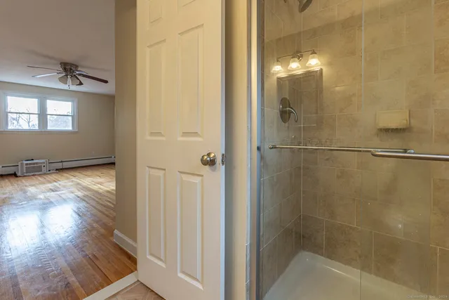 a bathroom with a glass shower door