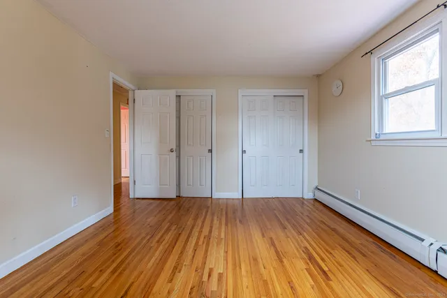 a view of a room with wooden floor and window