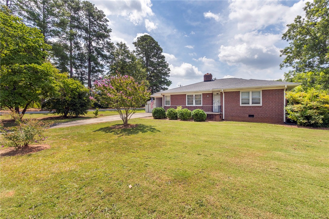 1218 Bolt Drive Anderson, SC 29621 - Photo 45 of 46 Mature trees and lush lawns frame this classic brick residence, exuding timeless appeal and comfortable living.