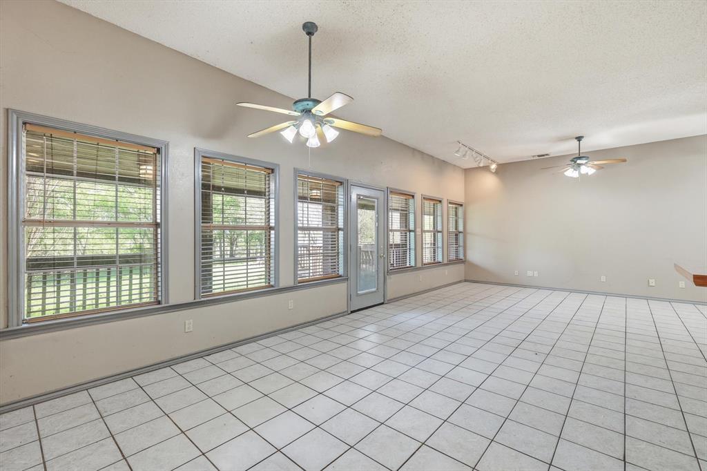 135 Private Road 2202 Decatur, TX 76234 - Photo 7 of 40 Empty room with a ceiling fan, rail lighting, and light tile patterned floors