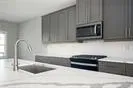 a kitchen with stainless steel appliances granite countertop a refrigerator a sink and a stove