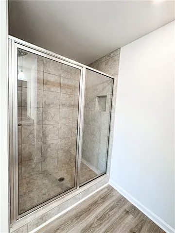 a bathroom with a glass shower door