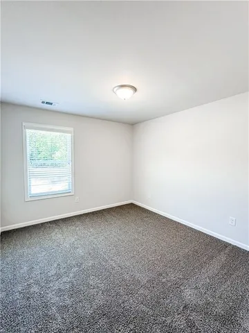 an empty room with a empty space and window