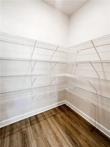 a view of a room with an empty space and wooden floor