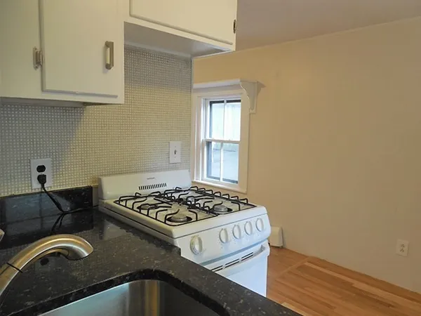 a black and white kitchen with a stove