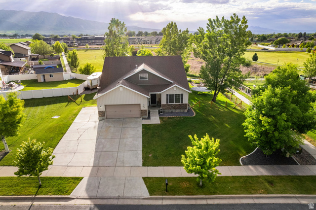 2485 South 1100th Street West Logan, UT 84321 - Photo 6 of 53 Two-story residence featuring a two-car garage, stone and siding exterior, and a dark shingle roof