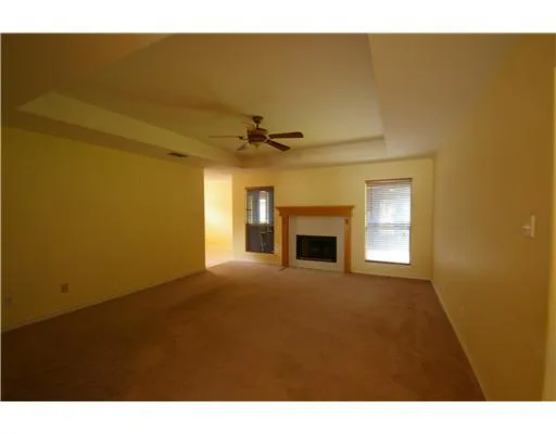 a view of an empty room and fire place