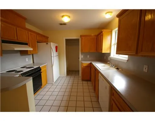 a kitchen with a sink appliances and cabinets