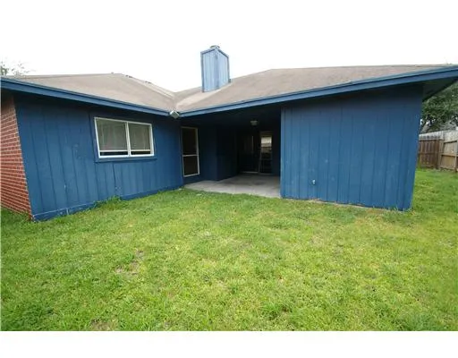 a view of an house with backyard space and balcony