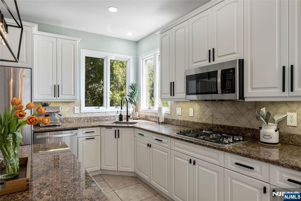 18 Renshaw Drive Montville, NJ 07045 - Photo 13 of 46 a kitchen with stainless steel appliances granite countertop a sink and cabinets