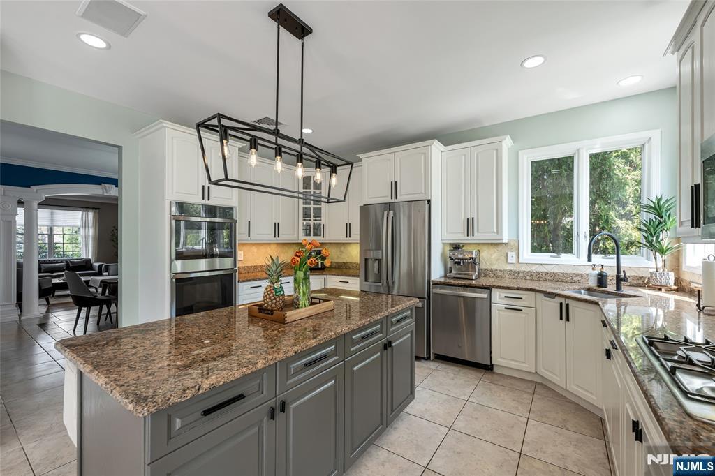 18 Renshaw Drive Montville, NJ 07045 - Photo 14 of 46 a kitchen with stainless steel appliances granite countertop a sink stove and refrigerator