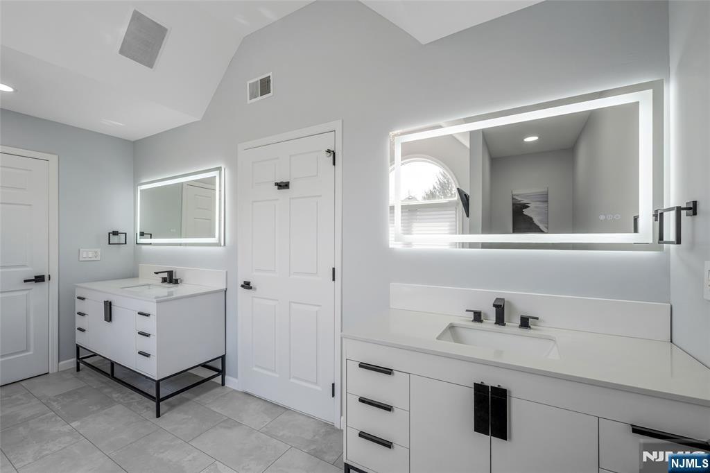 18 Renshaw Drive Montville, NJ 07045 - Photo 25 of 46 a bathroom with a double vanity sink and mirror