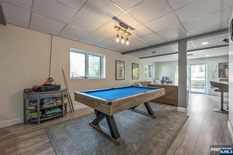 a room with pool table and windows