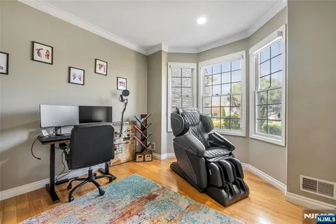 a view of a livingroom with workspace and a window