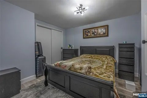 a bedroom with a bed and a chandelier