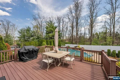 a view of a deck with furniture and trees