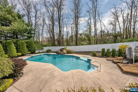 a view of a backyard with swimming pool
