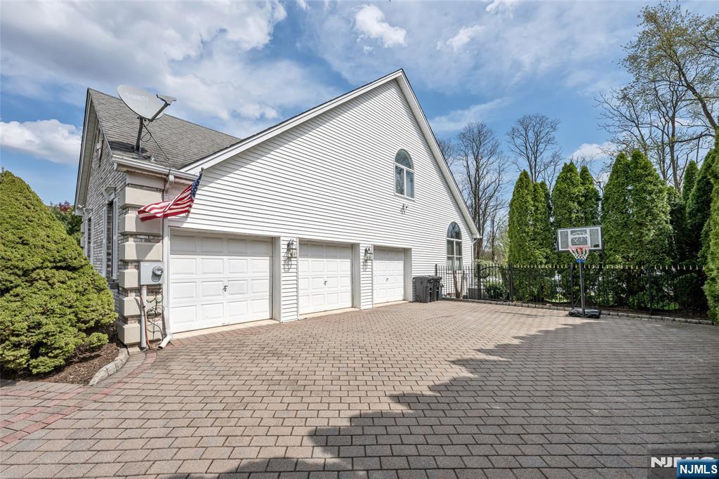 18 Renshaw Drive Montville, NJ 07045 - Photo 43 of 46 a front view of a house with a yard and garage