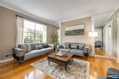a living room with furniture a flat screen tv and a large window