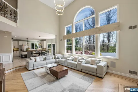 a living room with furniture fireplace and a large window