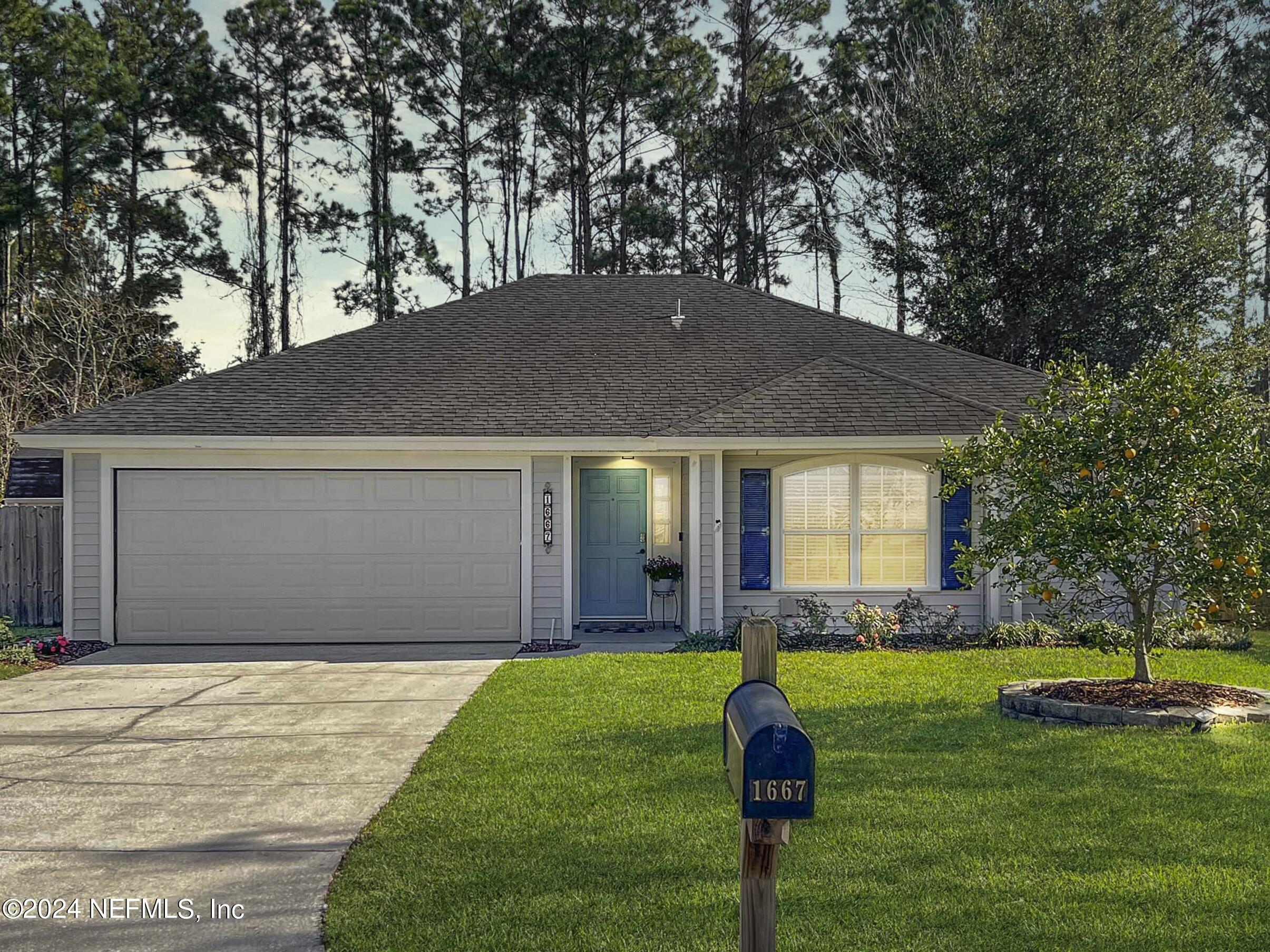 1667 Rusty Rail Road Jacksonville, FL 32225 - Photo 1 of 33 a front view of a house with a yard and garage