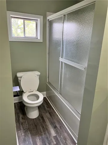 a white toilet sitting next to a window
