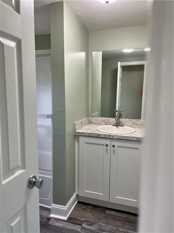 a bathroom with a granite countertop sink and a mirror