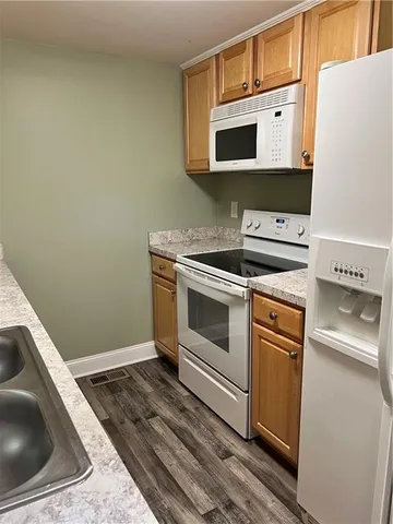 a kitchen with a stove microwave and sink