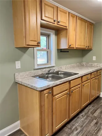 a kitchen with stainless steel appliances granite countertop a sink and cabinets