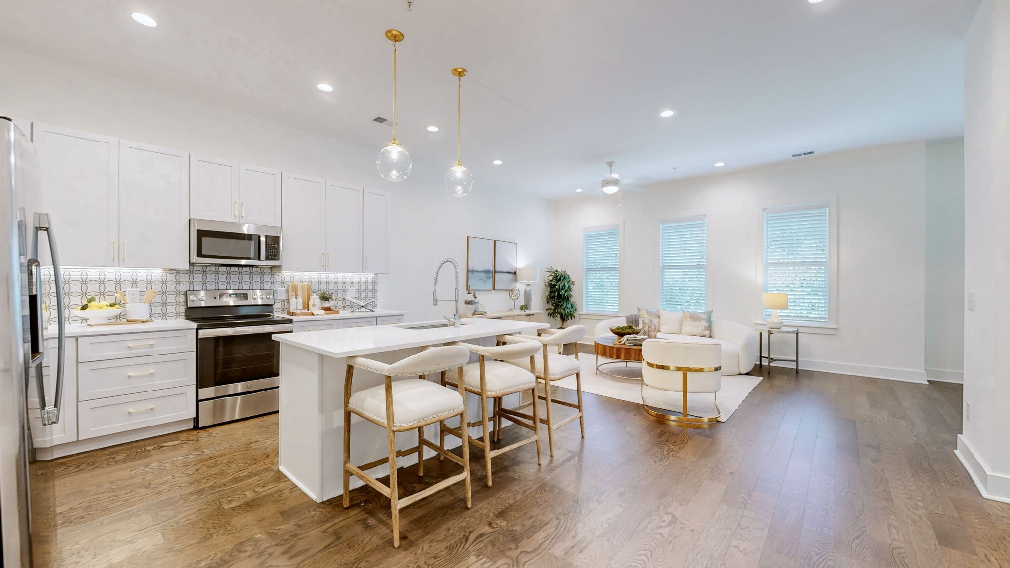 409 Herringbone Court Franklin, TN 37064 - Photo 2 of 36 a kitchen with a table chairs wooden floors and stainless steel appliances