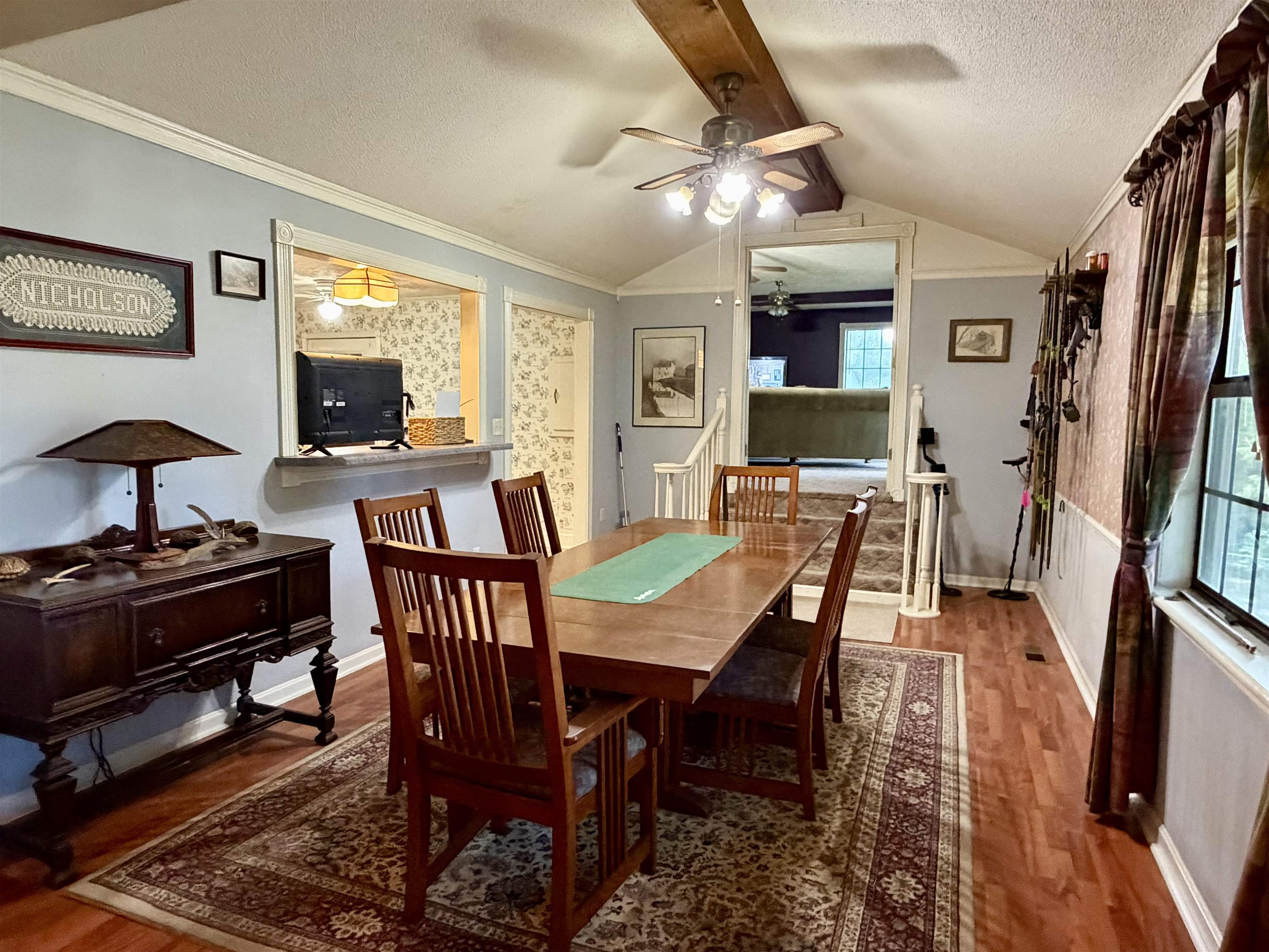 373 Clarence Barham Road Bethel Springs, TN 38315 - Photo 6 of 28 Dining area featuring wood-finish flooring, a vaulted ceiling with exposed beam, and a ceiling fan with integrated lighting