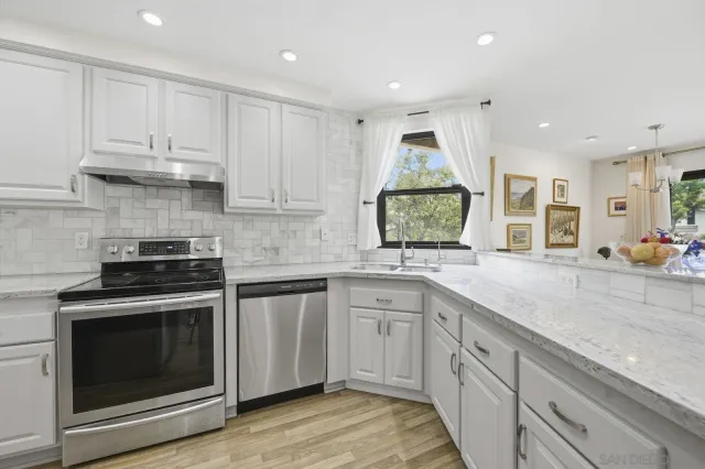 a kitchen with a sink stove and cabinets