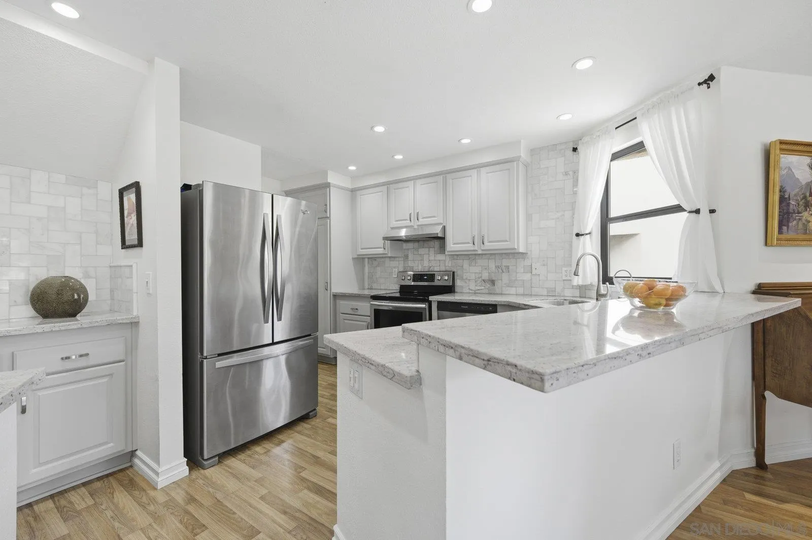 2742 Ariane Drive, Unit 153 San Diego, CA 92117 - Photo 12 of 43 a kitchen with stainless steel appliances granite countertop a refrigerator sink and cabinets