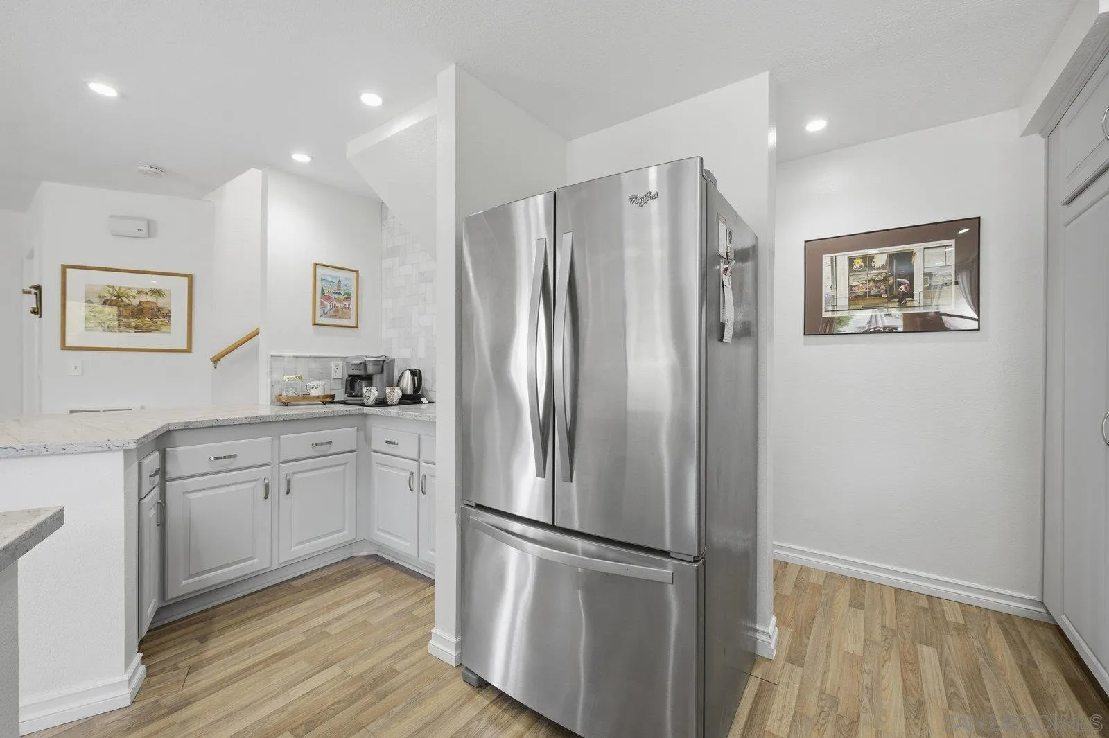 2742 Ariane Drive, Unit 153 San Diego, CA 92117 - Photo 13 of 43 a kitchen with stainless steel appliances granite countertop a refrigerator sink and wooden floor